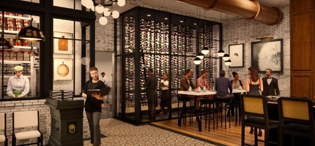 Interior look at glass enclosed wine room with a high table and guests. In the left side is a look at a corner of the pasta making room. 